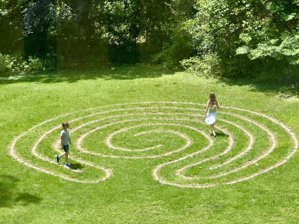 Two kids walk the labyrinth